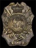 The Royal Regiment of Artillery, a very rare officer’s shako plate c1800-12, in die-stamped copper gilt, the back...