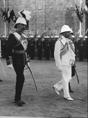 Photograph, of Lord Kitchener, The King and Governor-General Wingate walking through Suakin during the 1911...