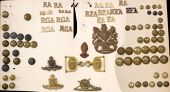 Royal Artillery Insignia. Comprising two o/r QVC helmet plates (the unicorn’s horn missing on one) and a similar...