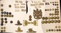 Royal Artillery Insignia. Comprising two o/r QVC helmet plates (the unicorn’s horn missing on one) and a similar...
