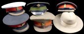 A Collection of Forage Caps. Comprising two Field Officers’ peaked caps the peaks inlaid with gold lace, one to...