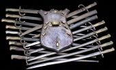 Bayonets. Comprising eleven Chassepot four with scabbards, and including a wooden display plaque, three Lebel, two...
