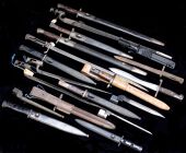 Bayonets. Assorted examples mainly European late 19th C to late 20th C, twelve with scabbards, four in relic state,...