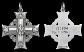 A Canadian Memorial Cross awarded in remembrance of Private F. Binns, 18th (Western Ontario) Battalion, who, having...