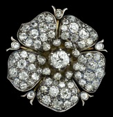 A Victorian diamond flowerhead brooch, modelled as a dog rose, the five petals pave set with graduated old...