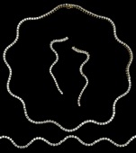 An 18ct gold and diamond suite, of wriggle design, the matched suite comprising a diamond line necklace by maker...