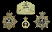 The Welsh Regiment Officers and Other Ranks Head Dress Badges, comprising a QVC period officer’s helmet plate...