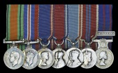 The mounted group of seven miniature dress medals worn by Mr. C. Oulton, Palace Steward, Buckingham...