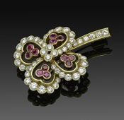 A ruby and diamond four petal flower brooch, by Cartier, with central quatrefoil of diamonds, within four...