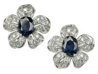 A pair of sapphire and diamond flower earclips, the two flowerheads centred with oval mixed-cut sapphires each...