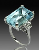 An Art Deco platinum, aquamarine and diamond dress ring, the rectangular step-cut aquamarine in four claw setting...