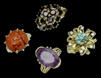 Four various dress rings, 1950s-1960s, including a carved red lacquer cabochon set example, a dress ring centred...