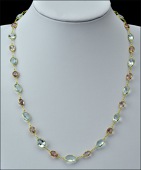 A pink tourmaline and aquamarine spectacle set long chain necklace, the slightly graduated alternating stones of...