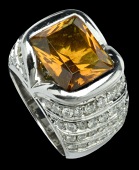 A citrine and diamond cocktail ring by Valente, the rectangular step-cut citrine split collet set between raised...