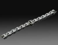 An Art Deco diamond set bracelet, the geometric open links set with single-cut diamonds to central collet set square...