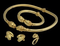 A Greek 18ct gold matched suite by Zolotas, comprising a torque choker necklace, a torque bangle, a ring and...
