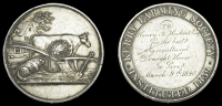 Kerry Farming Society, a silver award medal by T.W. Ingram, bull, sheep, bale of hay, plough and spade, house and...