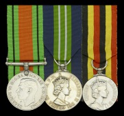 Three: J. B. Pollock, Esq., Uganda Government Service

Defence Medal, in named card box of issue, addressed to...