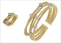 A diamond bangle and ring suite, the openwork sprung bangle composed of cable-link bands interspersed with...
