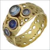 A gem-set dress ring by Alan Vallis, 2005, the textured band with pierced decoration and applied to the front with...