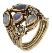 A moonstone dress ring, of Art Nouveau style, the sinuous design incorporating pear-shaped cabochon moonstones and...