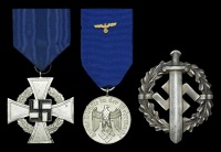 A German Second War Group of Three.
Comprising an excellent condition National Faithful Service Medal, good...