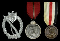 A German Second War Group of Three.
Comprising an Infantry Assault Badge in silver, solid construction, non maker...