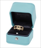 An ‘Atlas’ ring by Tiffany & Co, the openwork band comprising the Roman numerals 3, 6, 9 and 12 between polished...