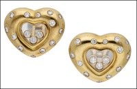 A pair of ‘Happy Diamond’ ear clips by Chopard, the central signed heart-shaped glazed compartments enclosing...