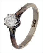 A solitaire diamond ring, the brilliant-cut diamond in eight claw setting, shank stamped ‘18ct’, total diamond...