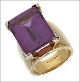 A silver gilt glass ring, by Swarovski, the broad tapered band centred with a rectangular purple glass cabochon in...