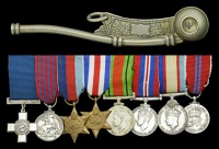 The mounted group of eight miniature dress medals worn by Lieutenant Commander J. S. Mould G.C., G.M., Royal...
