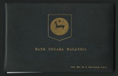 Bank Negara Malaysia, a leather presentation album with presented to TAN SRI W. H. Wilcock P.M.N, containing a set...