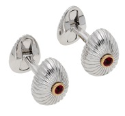 A pair of gem-set cufflinks by House of Fabergé, the egg-shaped terminals with fluted finish and centred with a...