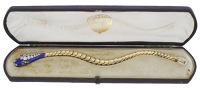 An enamel and diamond serpent bracelet, circa 1860, the snake-link gold chain with bloomed finish and leading to a...