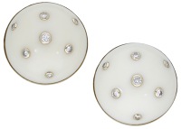 A pair of coral and diamond ear clips by Trianon, the circular white coral cabochons inset with brilliant-cut...