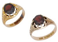 Two antique garnet rings, each claw-set with an oval-cut garnet in a 9ct gold mount with engraved foliate...