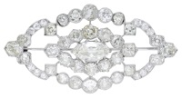 An Art Deco diamond brooch, circa 1930, set with a marquise-shaped diamond, weighing 2.88 carats, within an openwork...