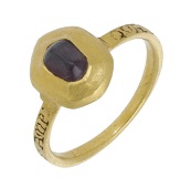 A Medieval gold and garnet posy ring, 13th century, the hexagonal pie-dish bezel centred with a pointed cabochon...