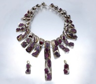 

A Britannia silver and ruby crystal collar necklace and earring suite by Louis Osman, 1974, the collar composed...