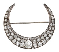 A late 19th century diamond crescent brooch, set throughout with graduated old brilliant, cushion and rose-cut...