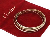 A ‘Semainier Trinity’ bangle by Cartier, formed of seven tricoloured 18ct gold polished bands, signed, maker’s...