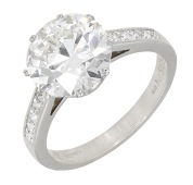 A diamond single stone ring, the transitional-cut diamond, weighing 4.70 carats, between shoulders set with...