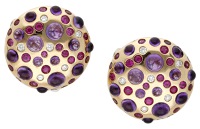 A pair of gem-set ear clips by Rodney Rayner, of circular domed form, set with amethyst cabochons, brilliant-cut...