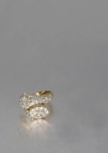 A diamond dress ring, French, retailed by Moussaieff, of bombé crossover design, each side set with an oval-cut...