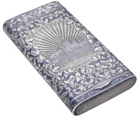 A  Russian late 19th century silver and niello cigar case, reserving a panel of the Kremlin and bridge over the...