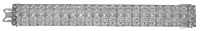 An Art Deco diamond bracelet, the articulated strap with pierced scallop decoration and set throughout with old...