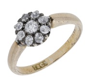 A diamond cluster ring, circa 1890, set with old brilliant-cut diamonds, mounted in silver and gold, stamped...