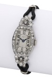Efico. A lady’s platinum and diamond-set tonneau-form cocktail watch, circa 1930.
Movement: manual...