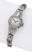 Swiss. A lady’s platinum and diamond-set Art Deco cocktail watch, circa 1930. 
Movement: manual winding.
Dial:...